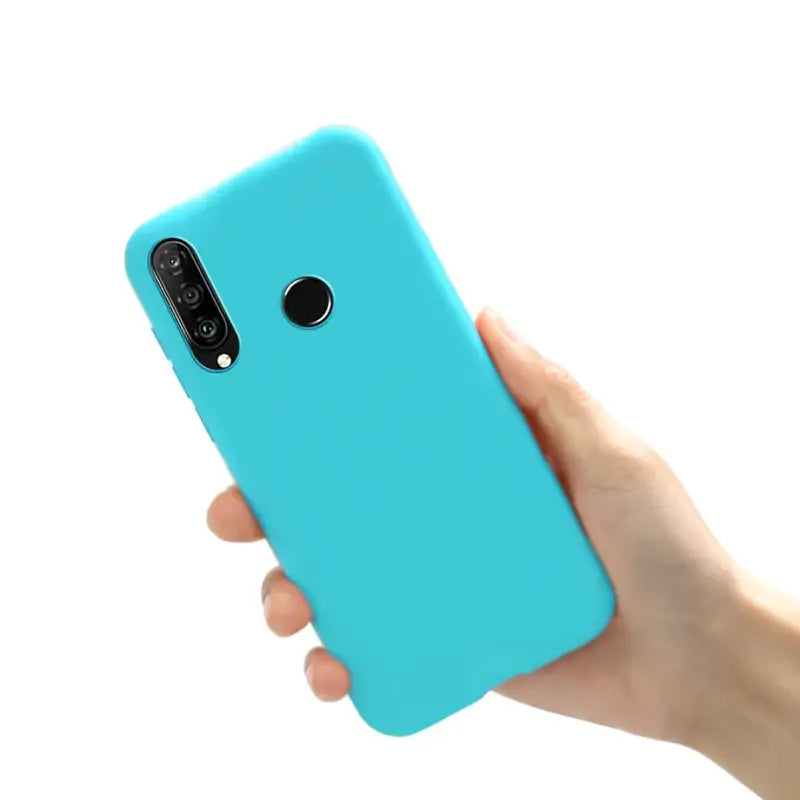 A hand holding a blue iphone case