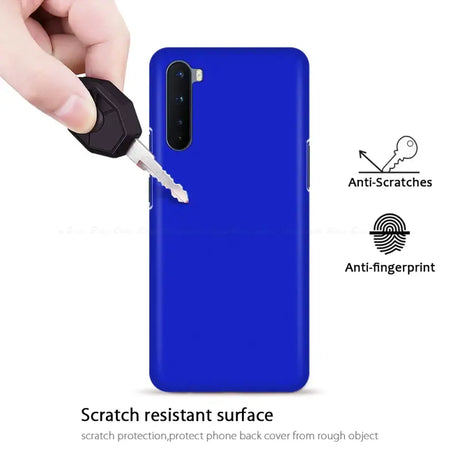 A hand holding a blue phone case with a key