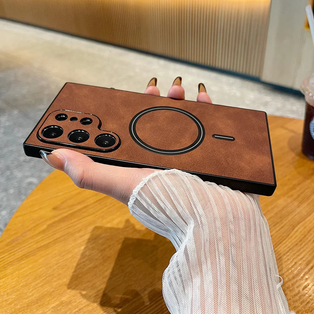 a hand holding a brown leather iphone case