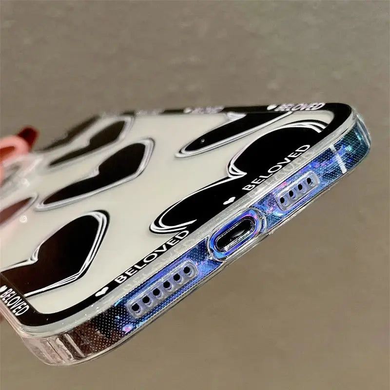 a hand holding a cell case with a black and white design