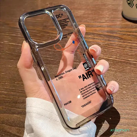 A hand holding a clear case with a clear back