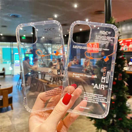 A hand holding a clear case with a picture of a plane