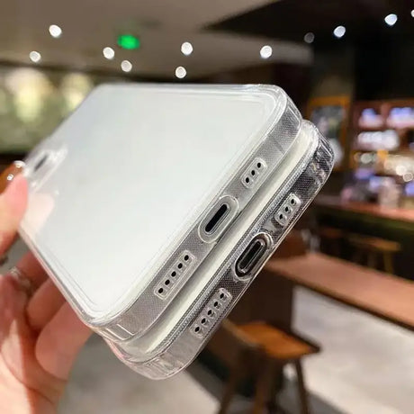 A hand holding a clear case with a white phone in it