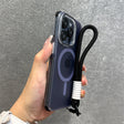 Hand holding a clear iPhone case with a black lanyard.