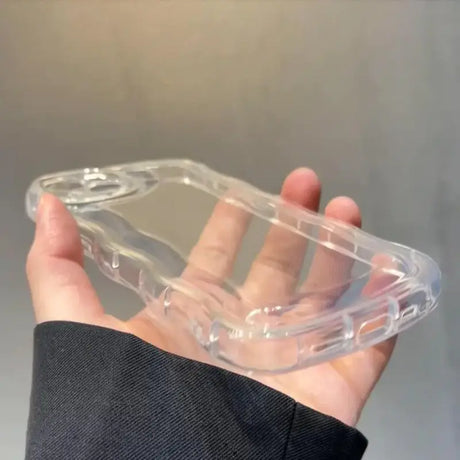 A hand holding a clear plastic case