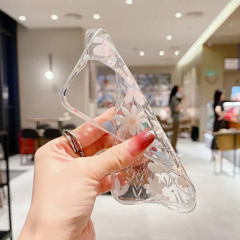 a hand holding a clear plastic object