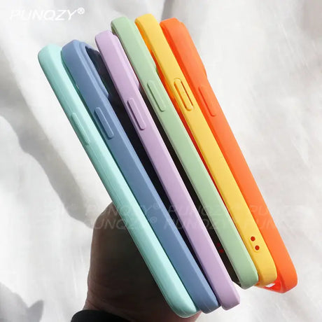 A hand holding a colorful phone case