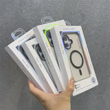A hand holding five boxed clear phone cases with a circular magnetic ring.