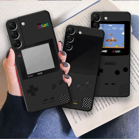 A hand holding a game boy phone case