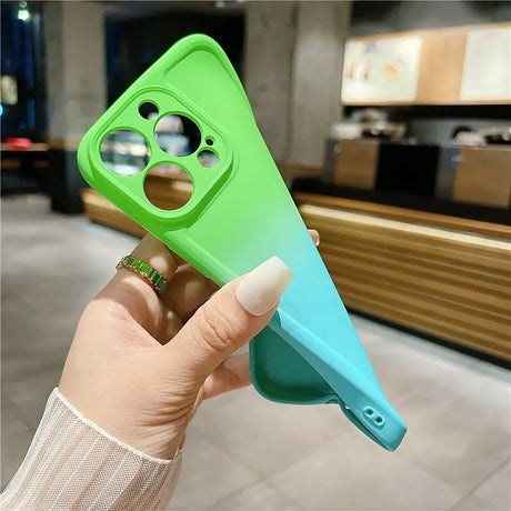 A hand holding a green and blue phone case