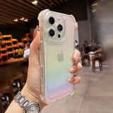 Hand holding an iPhone with a clear, iridescent, gradient phone case.