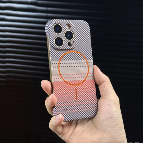 A hand holding an iPhone with a patterned case featuring a MagSafe ring.