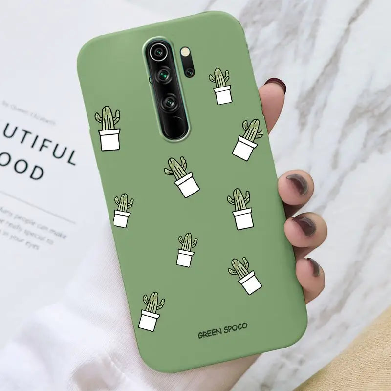 a hand holding a phone case with cactus design