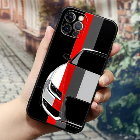 A hand holding a phone case with a car design