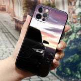 a hand holding a phone case with a car image on it