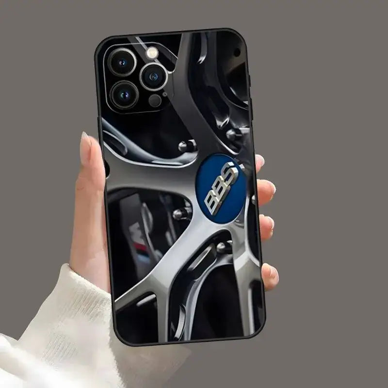 a hand holding a phone case with a car key