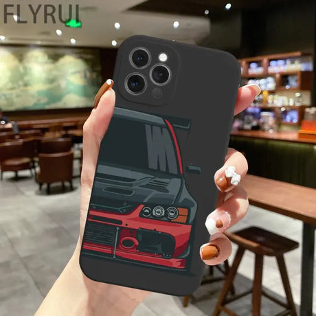 A hand holding a phone case with a car design