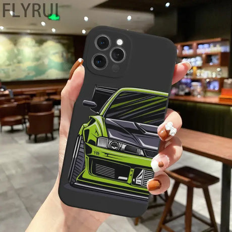 A hand holding a phone case with a car design