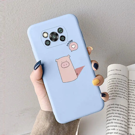 a hand holding a phone case with a cartoon pig on it