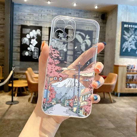 A hand holding a phone case with a cartoon drawing on it