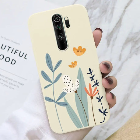 A hand holding a phone case with a flower design