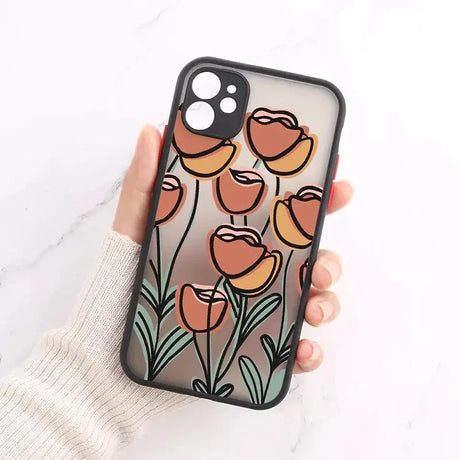 A hand holding a phone case with a flower design