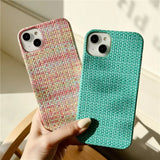a hand holding a phone case with a green and pink pattern