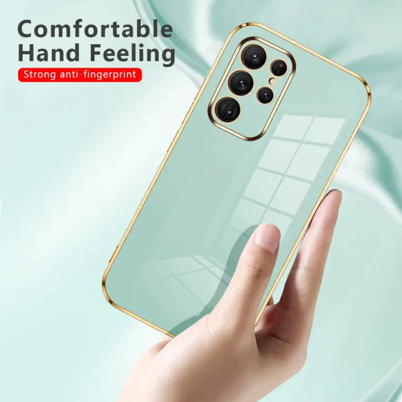 a hand holding a phone case with a mirror