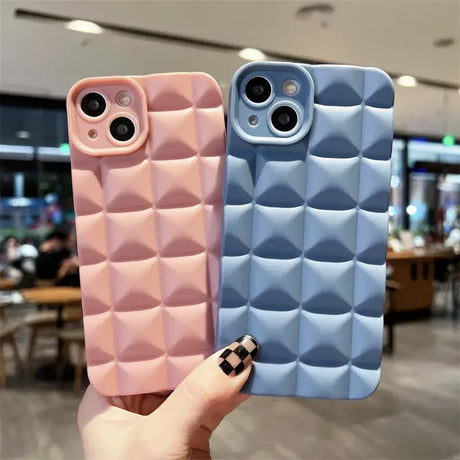 A hand holding a phone case with a pattern on it