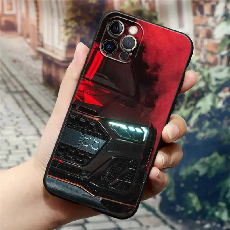 a hand holding a phone case with a red and black car