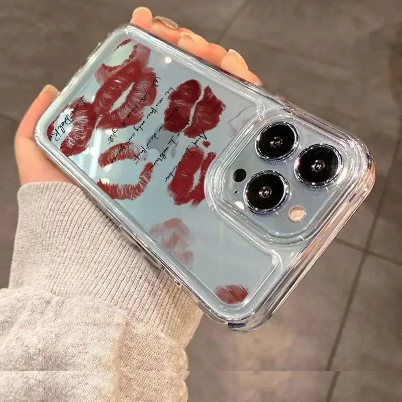 a hand holding a phone case with red lipstick on it