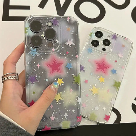 A hand holding a phone case with stars on it