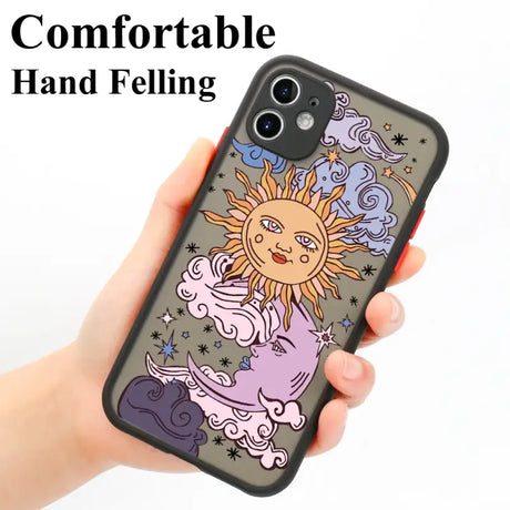 A hand holding a phone case with a drawing of a sun and stars