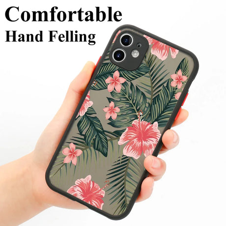 A hand holding a phone case with a tropical print