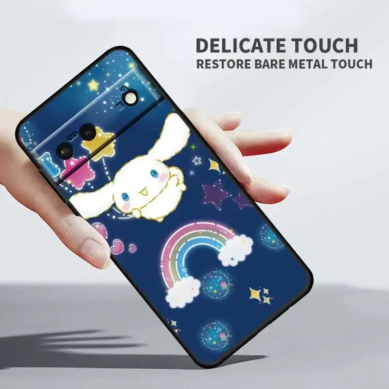 A hand holding a phone case with a unicorn on it