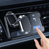 a hand holding a phone in the center of a car