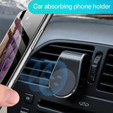 a hand holding a phone in the dashboard of a car