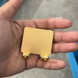 a hand holding a piece of gold
