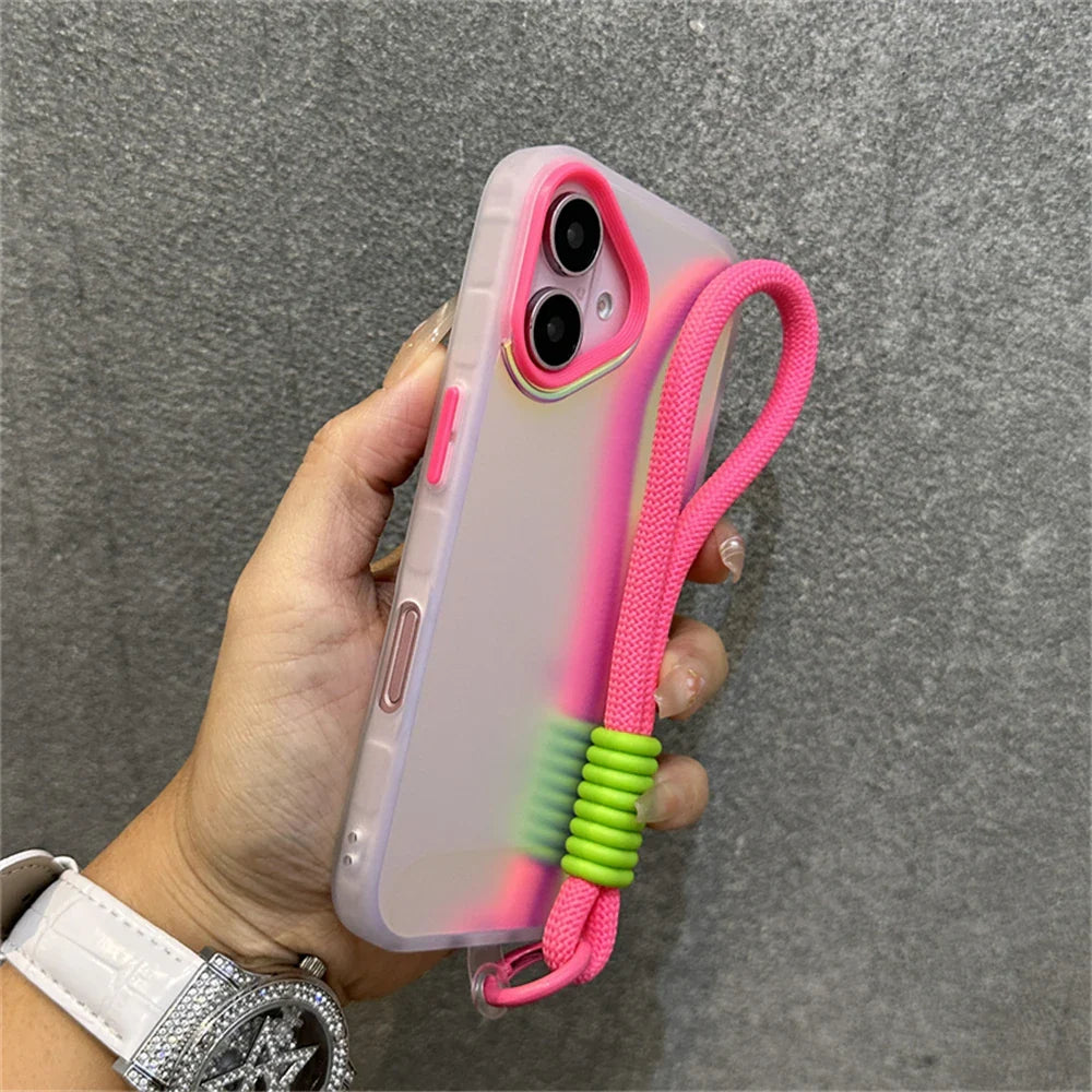 Hand holding a pink-accented phone case with a matching lanyard.