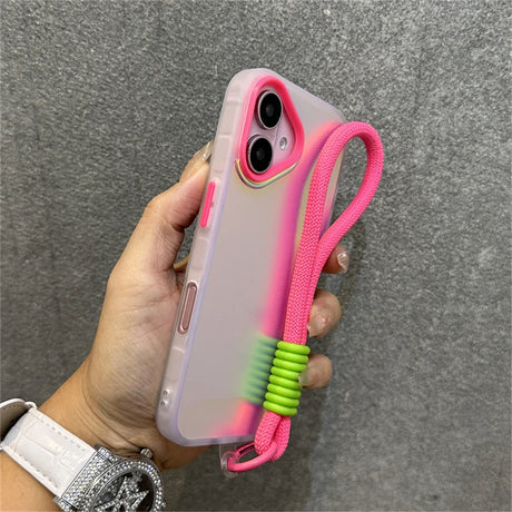 Hand holding a pink-accented phone case with a matching lanyard.