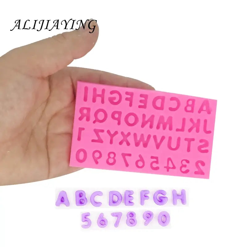 a hand holding a pink eraser with the letters