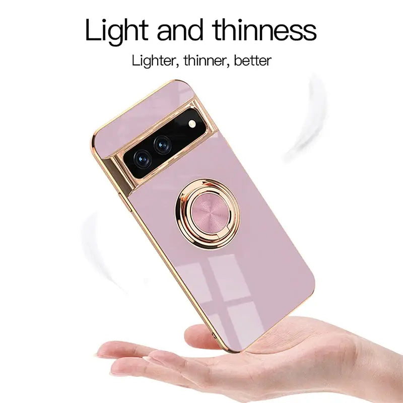 a hand holding a pink phone case with a camera