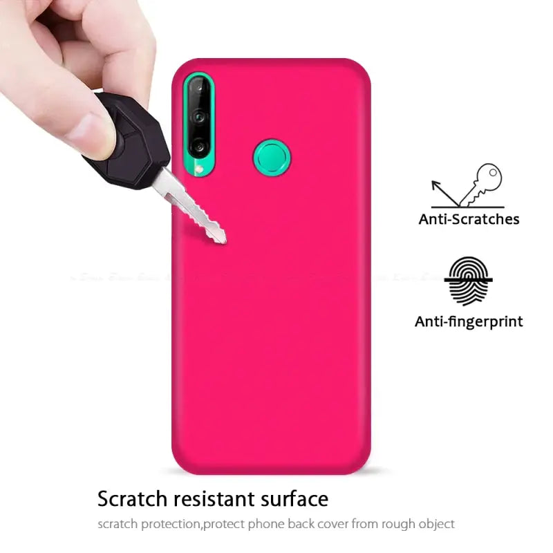 a hand holding a pink phone case with a key