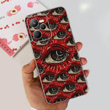 a hand holding a red phone case with an eye pattern
