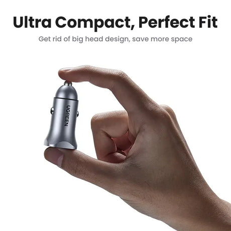 A hand holding a small device with the words ultra compact