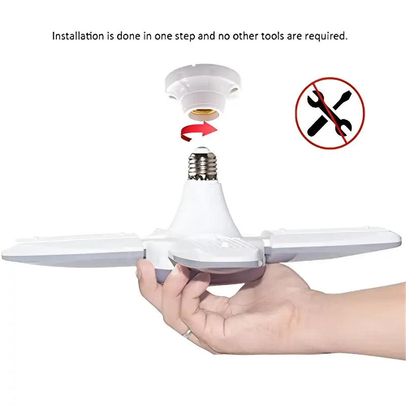 a hand holding a small propeller with a red light