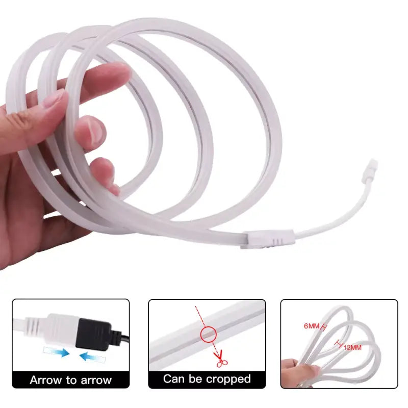 A hand holding a white cable with a white cord