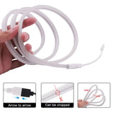 a hand holding a white cable with a white cord