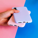 a hand holding a white iphone case