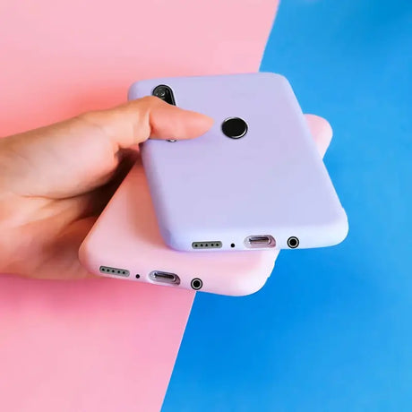 A hand holding a white iphone case